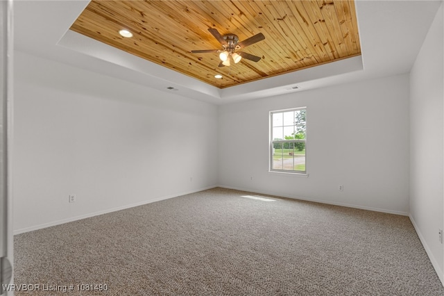 8601 Corona Ct, Uniontown, AR 72955 - unfurnished room featuring a raised ceiling, wooden ceiling, carpet flooring, a ceiling fan, and baseboards