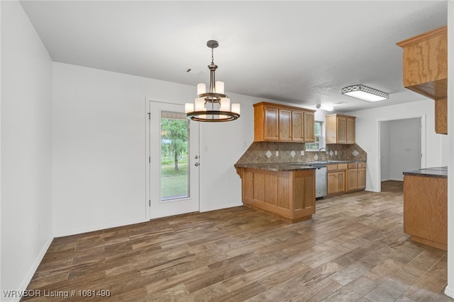 8601 Corona Ct, Uniontown, AR 72955 - kitchen with dishwasher, dark countertops, a peninsula, and decorative backsplash