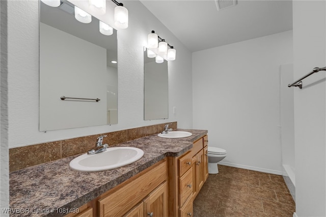 8601 Corona Ct, Uniontown, AR 72955 - full bathroom featuring double vanity, toilet, and baseboards