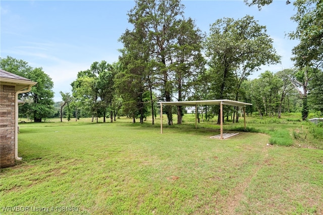 8601 Corona Ct, Uniontown, AR 72955 - view of green lawn with a carport