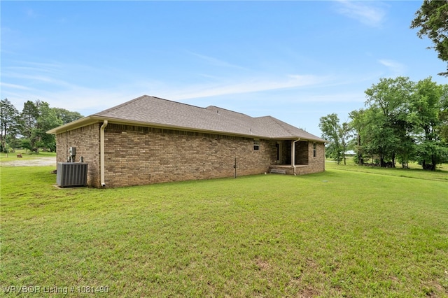 8601 Corona Ct, Uniontown, AR 72955 - back of house with a yard, brick siding, central air condition unit, and a shingled roof