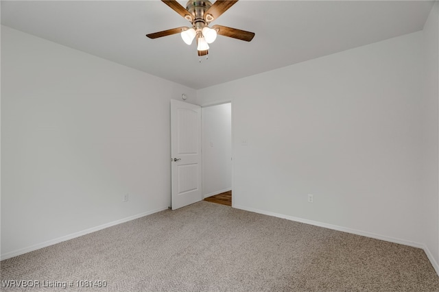 8601 Corona Ct, Uniontown, AR 72955 - spare room featuring carpet floors, ceiling fan, and baseboards