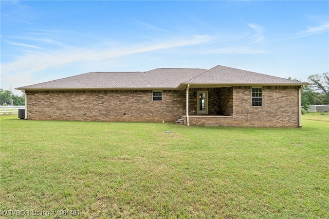 8601 Corona Ct, Uniontown, AR 72955 - rear view of house featuring a yard, central AC, brick siding, and roof with shingles