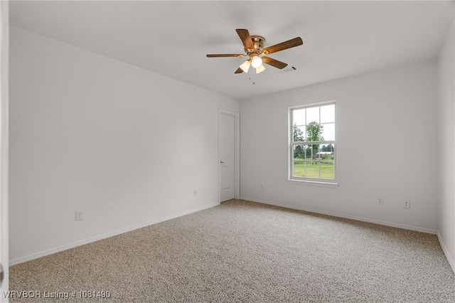 8601 Corona Ct, Uniontown, AR 72955 - spare room featuring light carpet, a ceiling fan, and baseboards