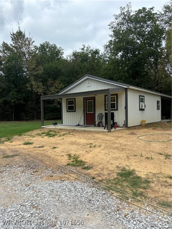 view of outbuilding featuring a porch and cooling unit