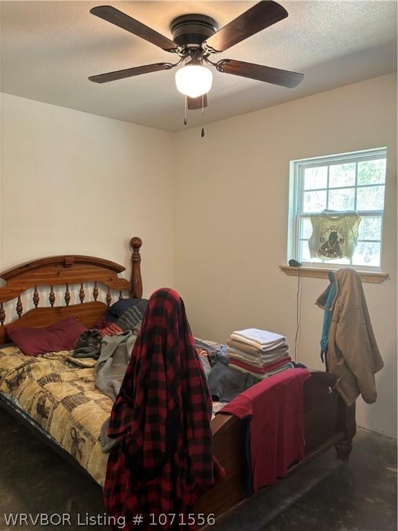 bedroom with concrete floors and ceiling fan