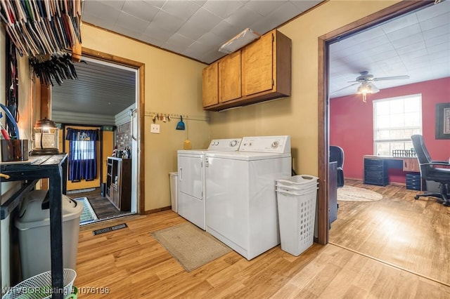 clothes washing area featuring washer and dryer, ceiling fan, cabinets, and light wood-type flooring