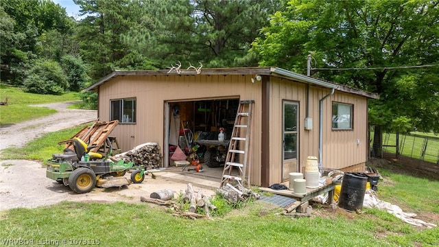 view of outbuilding featuring a yard and a garage