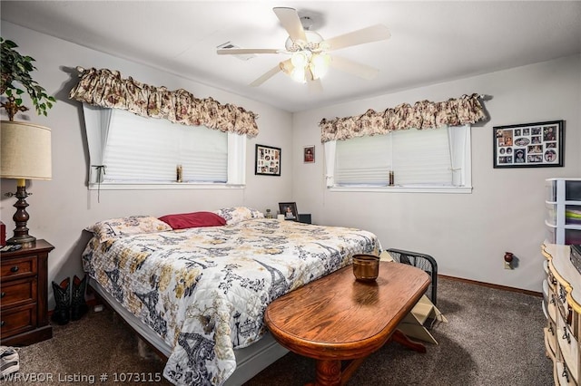 bedroom featuring dark colored carpet, ceiling fan, and multiple windows