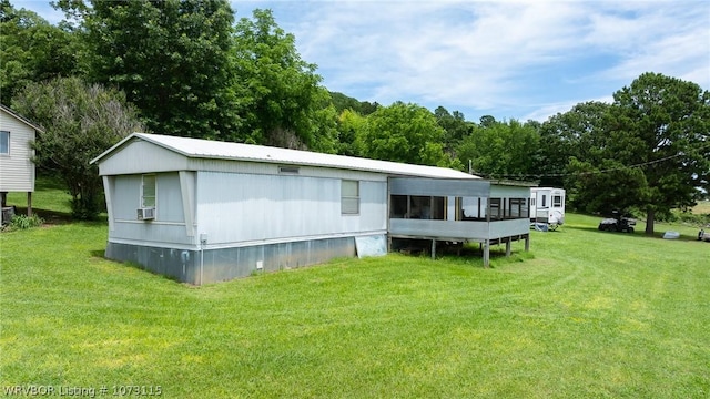 back of house featuring a lawn