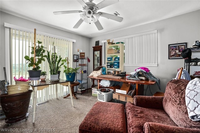 carpeted office featuring ceiling fan