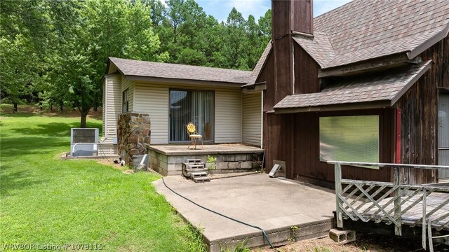 back of house featuring a patio area and a lawn