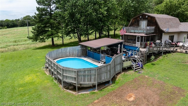 view of swimming pool with a wooden deck and a lawn