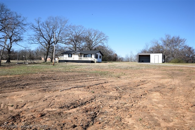 view of yard with an outbuilding and a detached garage