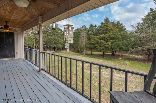 deck featuring ceiling fan and a lawn