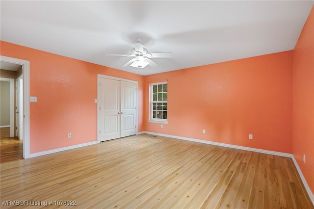 empty room featuring ceiling fan and light hardwood / wood-style floors