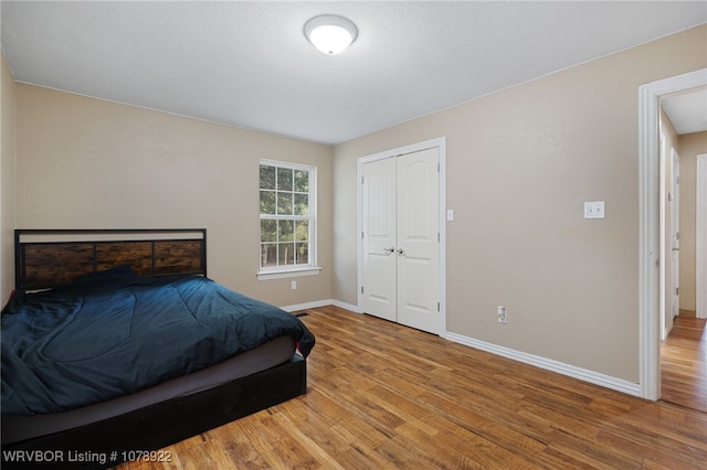 bedroom featuring hardwood / wood-style floors and a closet