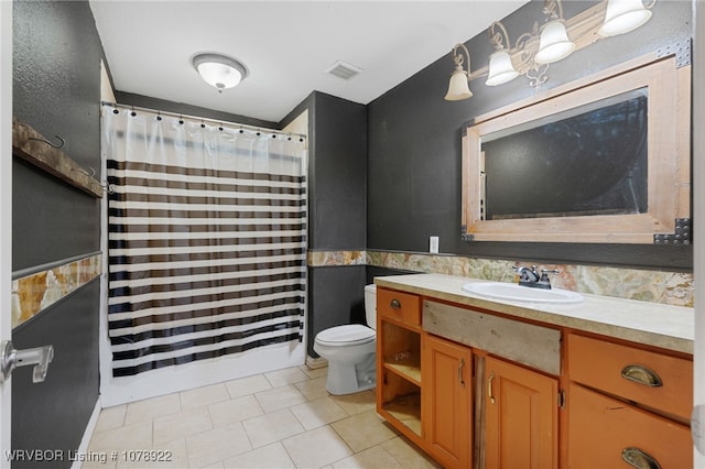 bathroom with vanity, tile patterned flooring, and toilet