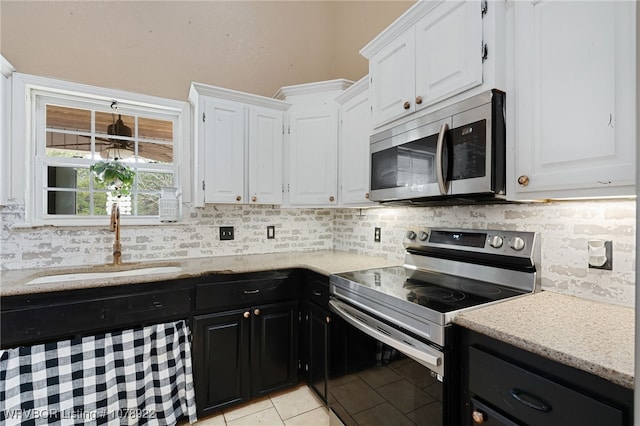 kitchen featuring backsplash, appliances with stainless steel finishes, sink, and white cabinets