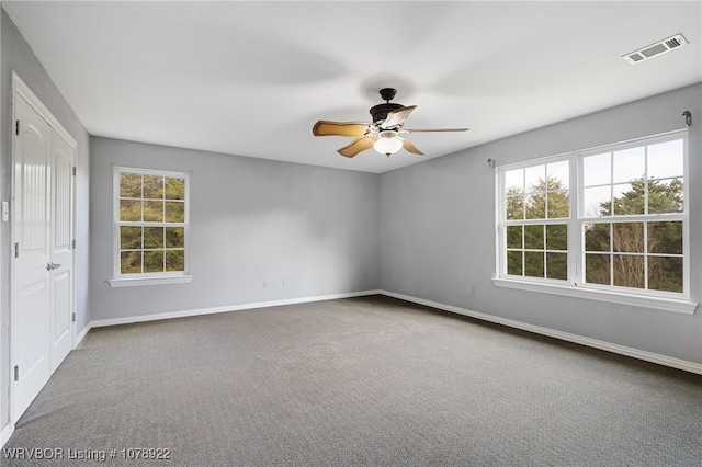 unfurnished room featuring ceiling fan and carpet flooring