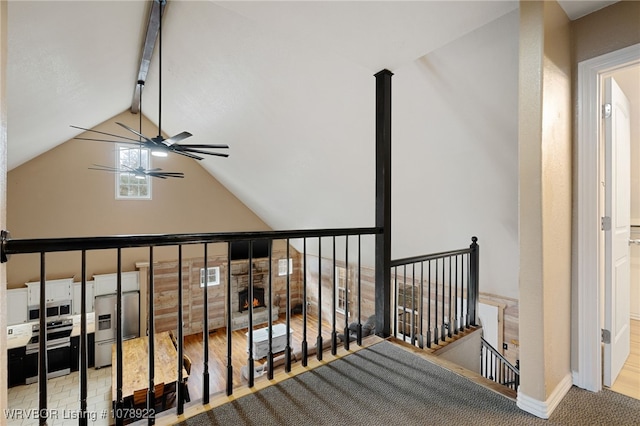 staircase featuring lofted ceiling with beams and ceiling fan