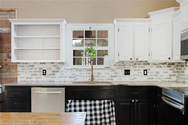 kitchen featuring sink, appliances with stainless steel finishes, white cabinets, light stone countertops, and backsplash