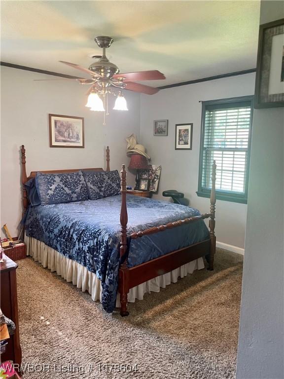 bedroom with crown molding, carpet floors, and ceiling fan