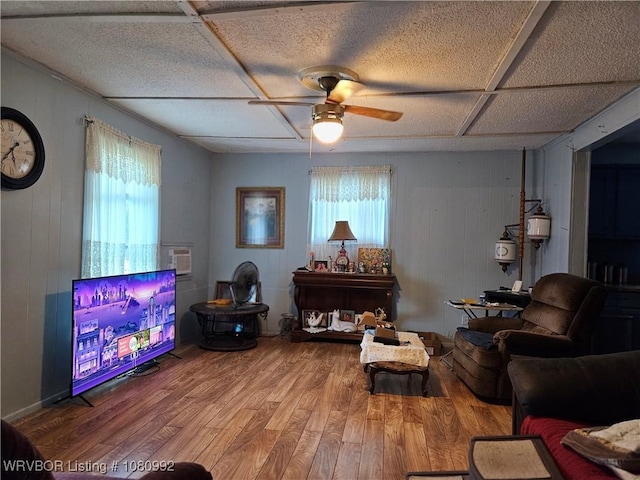 511 W Avenue E Street, Heavener, OK 74937 - living area with ceiling fan, wood finished floors, and wood walls