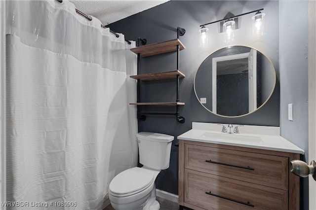 bathroom featuring toilet, vanity, and curtained shower