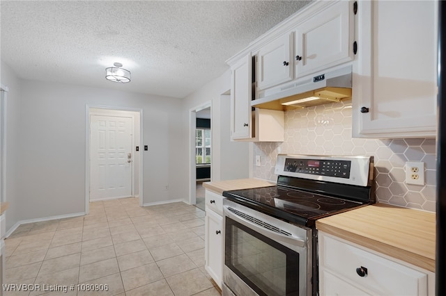 kitchen featuring stainless steel electric range oven, under cabinet range hood, decorative backsplash, baseboards, and white cabinets
