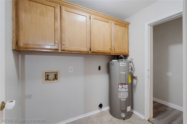 clothes washing area with water heater, hookup for an electric dryer, cabinet space, washer hookup, and light tile patterned floors