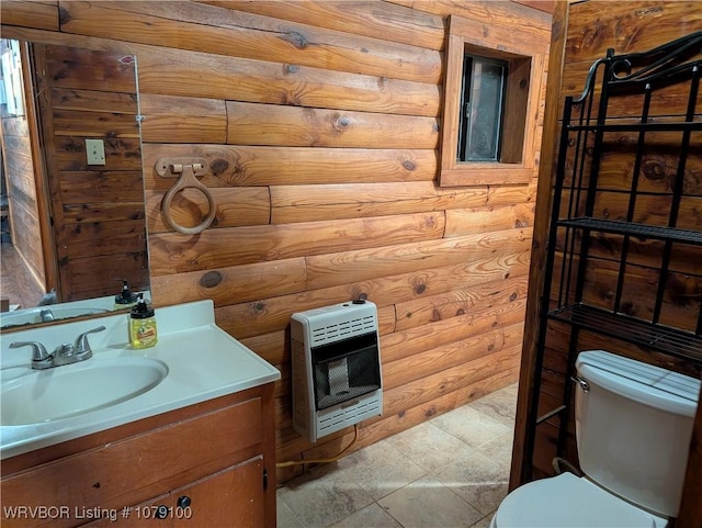 half bathroom with vanity, toilet, and heating unit