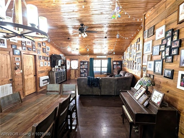 dining area featuring wooden ceiling, wood walls, vaulted ceiling, heating unit, and dark wood finished floors