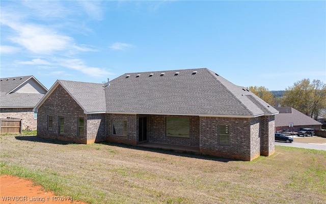 back of house featuring a lawn