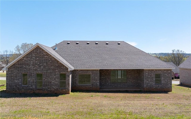 back of property featuring a lawn