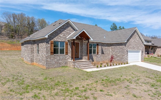 view of front of house featuring a garage and a front lawn