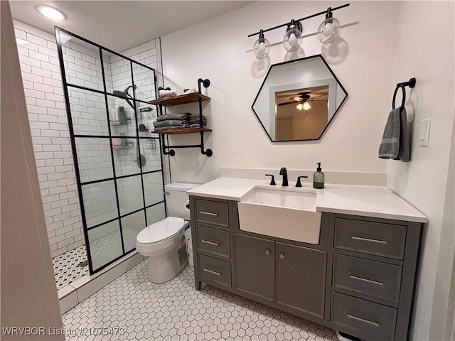 bathroom with vanity, tile patterned flooring, ceiling fan, toilet, and tiled shower