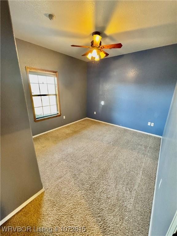 carpeted empty room featuring ceiling fan