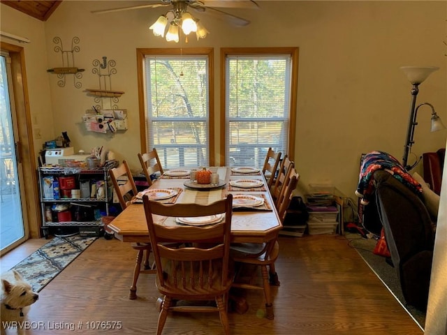 dining area featuring hardwood / wood-style flooring, ceiling fan, and vaulted ceiling