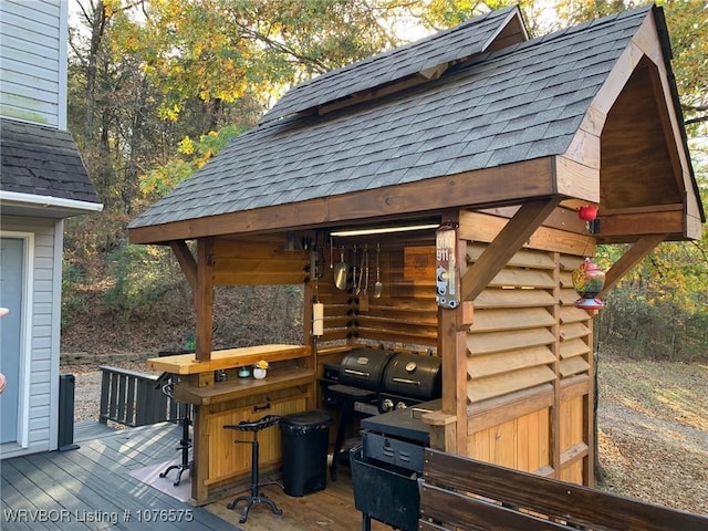 wooden deck featuring a grill