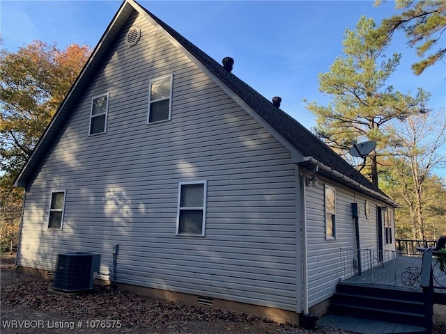 view of home's exterior featuring cooling unit and a deck