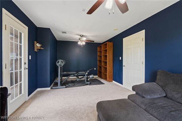 carpeted living room with a ceiling fan and baseboards