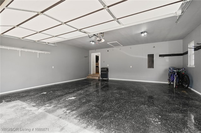 garage featuring electric panel, baseboards, and a garage door opener