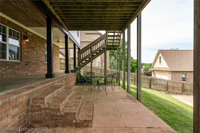 view of patio / terrace with stairs, ceiling fan, and outdoor dining area