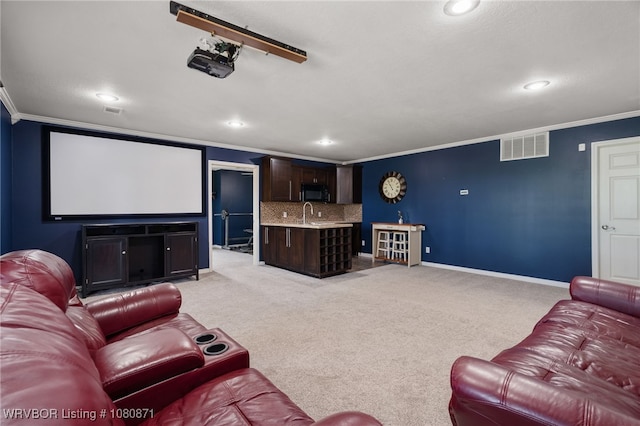 home theater featuring ornamental molding, recessed lighting, light colored carpet, and baseboards