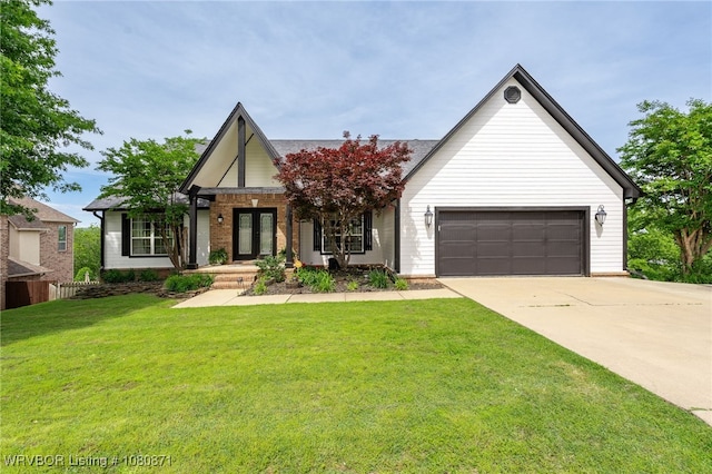 view of front facade with driveway, french doors, and brick siding