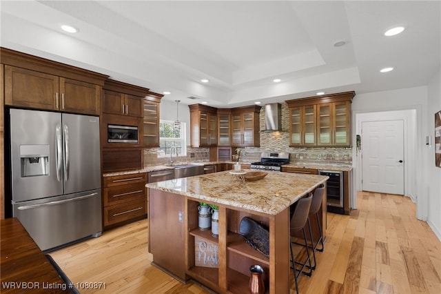 kitchen with stainless steel appliances, wall chimney exhaust hood, wine cooler, open shelves, and a sink