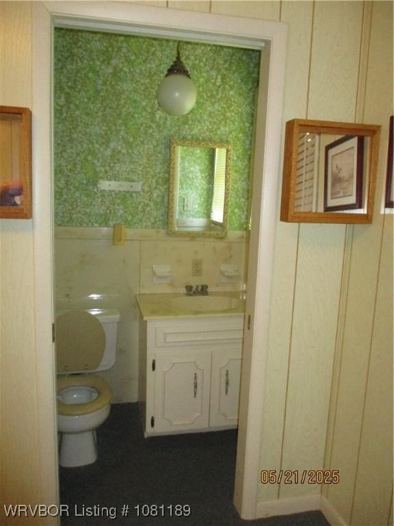 1501 18th St, Ozark, AR 72949 - bathroom featuring vanity, toilet, and tile walls
