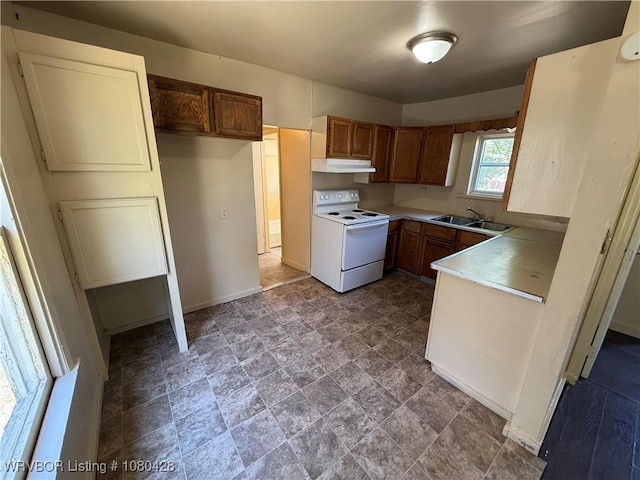 kitchen with under cabinet range hood, baseboards, a sink, electric stove, and light countertops