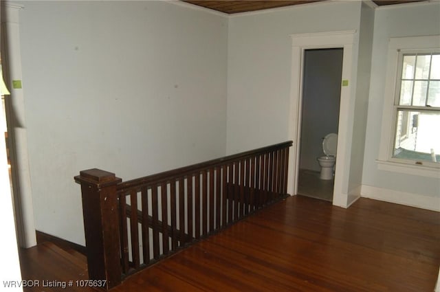 staircase featuring crown molding and hardwood / wood-style flooring